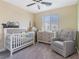 Charming Bedroom with a crib, dresser, and cozy rocking chair at 3585 Arcadian Sea St, Las Vegas, NV 89106