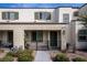 Charming home featuring a covered front porch, neutral stucco facade, and green shutters on the windows at 3585 Arcadian Sea St, Las Vegas, NV 89106