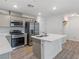 Modern kitchen featuring stainless steel appliances, quartz countertops, and a breakfast bar at 3585 Arcadian Sea St, Las Vegas, NV 89106