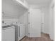 Bright laundry room featuring modern washer and dryer with overhead shelving for storage at 3585 Arcadian Sea St, Las Vegas, NV 89106