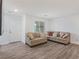 Cozy living room with neutral decor, a window, and wood-look flooring at 3585 Arcadian Sea St, Las Vegas, NV 89106