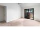 Well-lit bedroom boasts neutral carpet and sliding glass door at 3740 Desert Marina Dr # 2, Laughlin, NV 89029