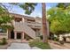 Charming condo building with inviting stairs, well-manicured landscaping, and mature trees at 3740 Desert Marina Dr # 2, Laughlin, NV 89029