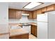 Well-lit kitchen equipped with wood cabinets, white appliances, and durable countertops at 3740 Desert Marina Dr # 2, Laughlin, NV 89029