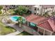 Aerial view of a community pool with a covered area, surrounded by lush greenery, and a well-maintained fence at 3740 Desert Marina Dr # 2, Laughlin, NV 89029
