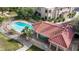 Aerial view of a community pool with a covered area, surrounded by lush greenery, and a well-maintained fence at 3740 Desert Marina Dr # 2, Laughlin, NV 89029