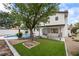 Landscaped backyard offering a pool, artificial grass, mature trees, and privacy at 389 Umbria Way, Henderson, NV 89014