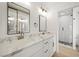 Elegant bathroom with dual sinks, marble countertops, and a glass-enclosed shower at 389 Umbria Way, Henderson, NV 89014