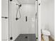 Modern bathroom featuring a sleek glass shower with black hardware and fixtures at 389 Umbria Way, Henderson, NV 89014