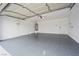 Spacious two-car garage with epoxy flooring, storage shelves, and a modern garage door opener at 389 Umbria Way, Henderson, NV 89014
