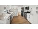 Bright kitchen with white cabinets, marble countertops, and modern stainless steel appliances at 389 Umbria Way, Henderson, NV 89014