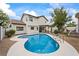 Enjoy the backyard oasis with private pool, grass area, and serene views of the home at 389 Umbria Way, Henderson, NV 89014