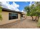 Low-maintenance backyard features desert landscaping and a covered patio, perfect for outdoor living at 4 Chatmoss Rd, Henderson, NV 89052