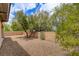 Spacious backyard with desert landscaping, a mature tree, and privacy walls at 4 Chatmoss Rd, Henderson, NV 89052