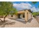 Backyard with covered patio, desert landscaping and mature tree at 4 Chatmoss Rd, Henderson, NV 89052