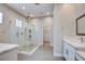 Modern bathroom featuring an oversized glass enclosed shower, dual shower heads, and updated fixtures at 4 Chatmoss Rd, Henderson, NV 89052