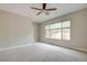 The bedroom has a ceiling fan, a large window that lets in lots of natural light and carpet floors at 4 Chatmoss Rd, Henderson, NV 89052