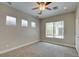 Well-lit bedroom with multiple windows, carpet, and a ceiling fan at 4 Chatmoss Rd, Henderson, NV 89052