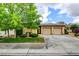 Charming single-story home with a two-car garage, lush landscaping, and desert-friendly greenery at 4 Chatmoss Rd, Henderson, NV 89052