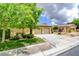 Attractive single-story home with a two-car garage, green lawn, and landscaped front yard at 4 Chatmoss Rd, Henderson, NV 89052