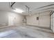 Spacious garage with cement floor, door to outside, and automatic opener at 4 Chatmoss Rd, Henderson, NV 89052