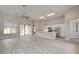 Open-concept floor plan features an island with white countertop, modern stainless steel appliances, and lots of natural light at 4 Chatmoss Rd, Henderson, NV 89052