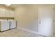 Laundry room with washer, dryer, storage and tile flooring at 4 Chatmoss Rd, Henderson, NV 89052