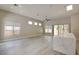 Spacious living room boasts wood floors, recessed lighting, ceiling fan and windows overlooking the outdoor space at 4 Chatmoss Rd, Henderson, NV 89052