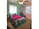 Inviting bedroom featuring pastel walls and large windows for great natural light, as well as a ceiling fan at 400 National St, Henderson, NV 89015
