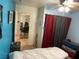 Comfortable bedroom features cool blue walls, tile floors, and a ceiling fan for extra comfort at 400 National St, Henderson, NV 89015