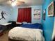 This bedroom features cool blue walls, baseball themed decorations, a desk and an open ceiling fan at 400 National St, Henderson, NV 89015
