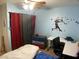 Bedroom features a ceiling fan, baseball-themed decorations, and functional furnishings at 400 National St, Henderson, NV 89015