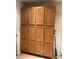 Spacious pantry featuring ample storage with oak colored cabinet doors and tile flooring at 400 National St, Henderson, NV 89015