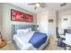 Inviting bedroom with comfortable bed, ceiling fan, and sports-themed decor at 409 Lake Windemere St, Las Vegas, NV 89138