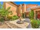 Beautiful courtyard displaying brick pavers, a fountain, mature trees and lush greenery at 409 Lake Windemere St, Las Vegas, NV 89138
