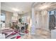 A stylish dining room featuring a modern chandelier, large dining table, and elegant tile floors at 409 Lake Windemere St, Las Vegas, NV 89138