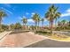 Elegant gated entrance to Paradiso community, featuring stone pillars, lush landscaping, mature palms, and a welcoming sign at 409 Lake Windemere St, Las Vegas, NV 89138
