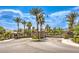 Gated community entrance featuring lush landscaping, mature palm trees and stone accents for an inviting curb appeal at 409 Lake Windemere St, Las Vegas, NV 89138