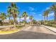 Stunning gated entrance to the Paradiso community showcases lush palm trees, beautiful landscaping and brick paved entry at 409 Lake Windemere St, Las Vegas, NV 89138