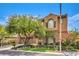 Inviting home featuring an attached three-car garage, stucco and stone accents, and lush landscaping at 409 Lake Windemere St, Las Vegas, NV 89138