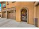 A close up of an arched entryway to the home, showing the attached garage and stone accents at 409 Lake Windemere St, Las Vegas, NV 89138