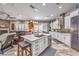 Open kitchen with island, pendant lights, stainless appliances, and seamless access to the living area at 409 Lake Windemere St, Las Vegas, NV 89138