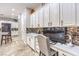 Built-in office space features white cabinets, quartz counters, and a stylish backsplash in this open-concept floor plan at 409 Lake Windemere St, Las Vegas, NV 89138