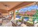 Relaxing outdoor patio featuring comfortable seating, a ceiling fan, and views of the pool and garden at 409 Lake Windemere St, Las Vegas, NV 89138
