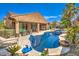 Backyard haven with a pristine pool, patio, mature landscaping, and grassy area offers a perfect blend of relaxation and recreation at 409 Lake Windemere St, Las Vegas, NV 89138