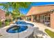 This backyard features a pool with a raised spa, covered patio and ample seating, perfect for outdoor entertaining at 409 Lake Windemere St, Las Vegas, NV 89138