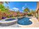 Private backyard oasis featuring a sparkling pool and spa, complemented by lush landscaping and serene surroundings at 409 Lake Windemere St, Las Vegas, NV 89138