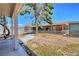 Backyard featuring an expansive yard with trees and the home's exterior at 4211 Bradley Rd, Las Vegas, NV 89130