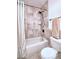 Cozy bathroom featuring a shower-tub combo with tiled walls and updated fixtures at 4211 Bradley Rd, Las Vegas, NV 89130