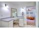Bathroom with granite-top vanity and a view into an adjacent room at 4211 Bradley Rd, Las Vegas, NV 89130